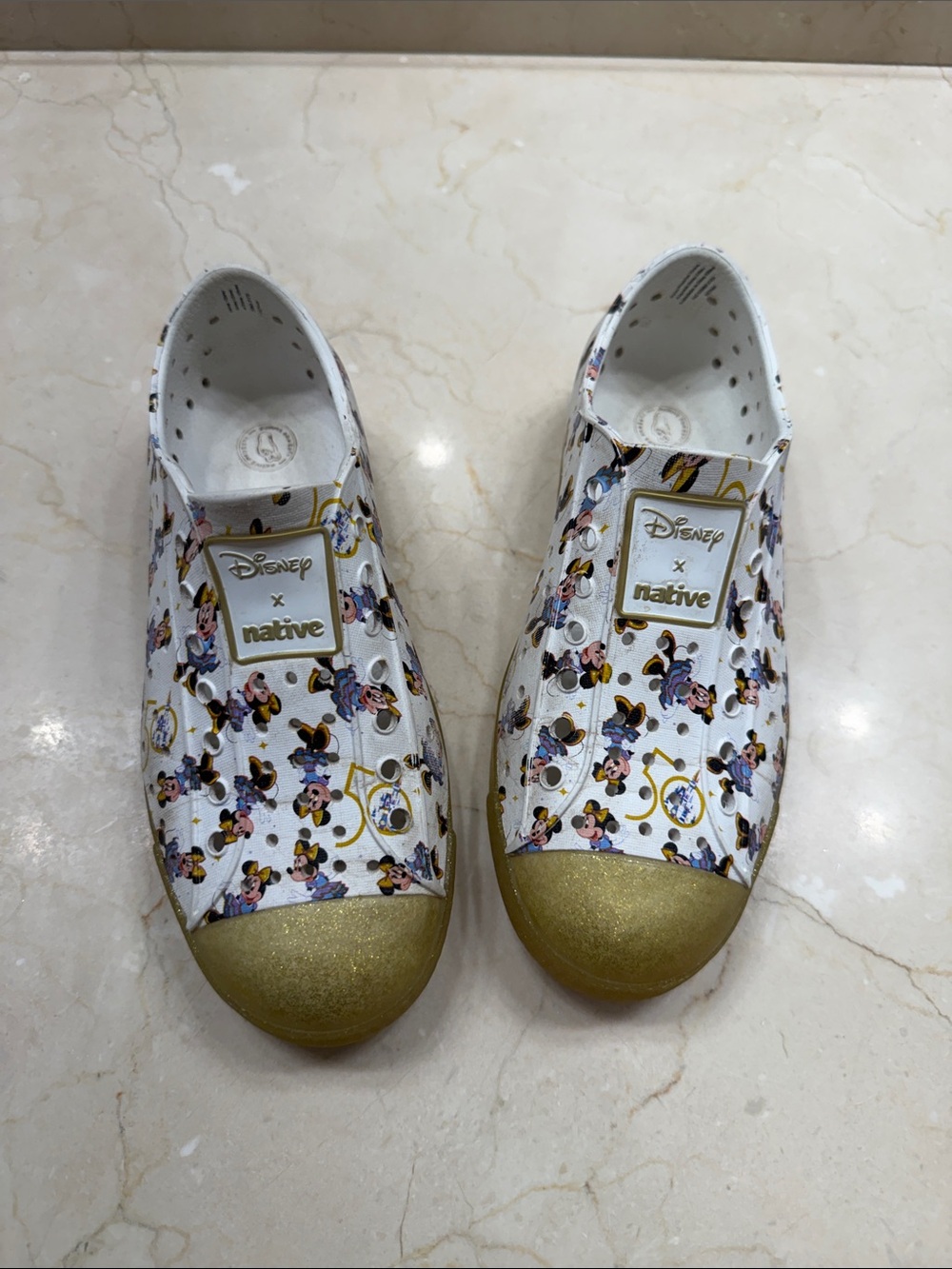 Native x Disney 50th Anniversary Slip-On Sneakers in White and Gold